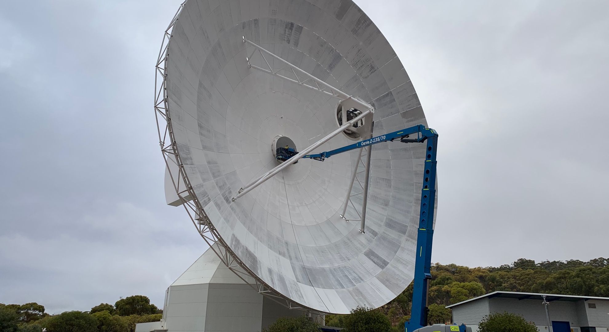APS boom lift working on a large satellite dish in regional Western Australia